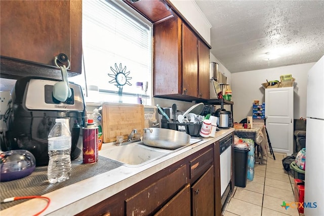 1203 Urbantke Ct Unit A-H, Copperas Cove, TX 76522 - kitchen with light countertops, dishwasher, light tile patterned flooring, a textured ceiling, and freestanding refrigerator