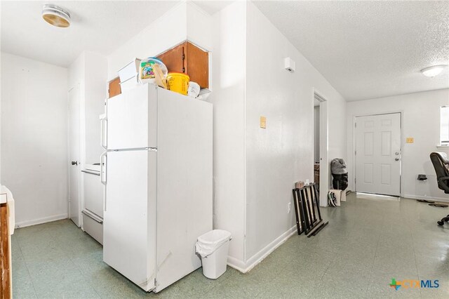 1203 Urbantke Ct Unit A-H, Copperas Cove, TX 76522 - kitchen with freestanding refrigerator, light flooring, and a textured ceiling