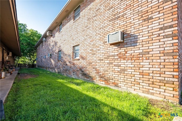 1203 Urbantke Ct Unit A-H, Copperas Cove, TX 76522 - view of home's exterior with brick siding, a lawn, and an AC wall unit