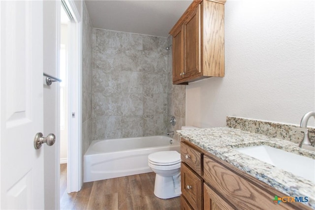 full bathroom with wood-type flooring, vanity, toilet, and tub / shower combination