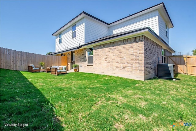 rear view of house with an outdoor living space, central air condition unit, and a lawn