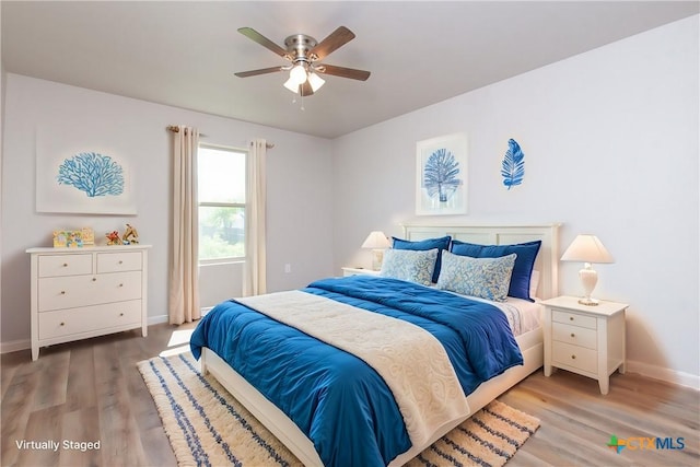 bedroom with wood-type flooring and ceiling fan