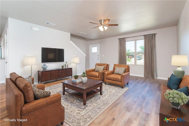 living room with hardwood / wood-style flooring and ceiling fan