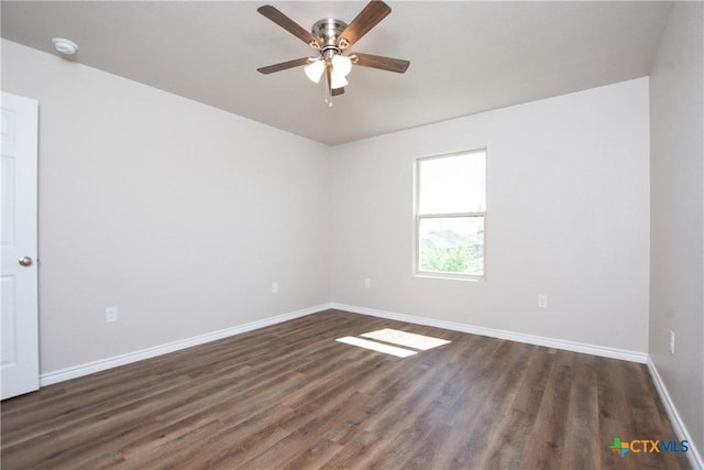 unfurnished room with dark hardwood / wood-style floors and ceiling fan