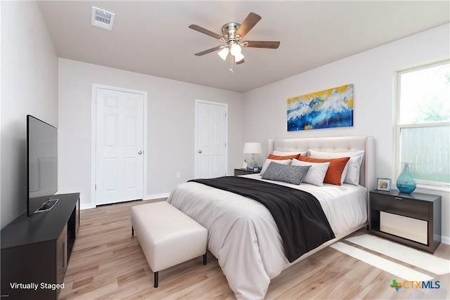 bedroom with light hardwood / wood-style floors and ceiling fan