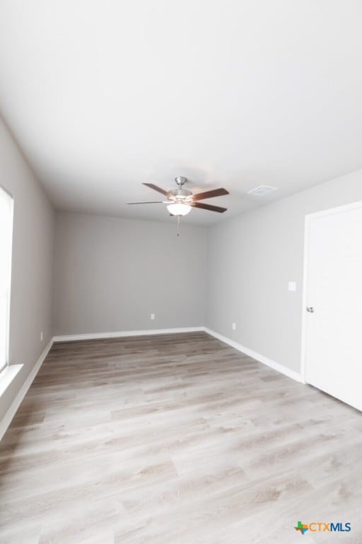 empty room featuring ceiling fan and light hardwood / wood-style flooring