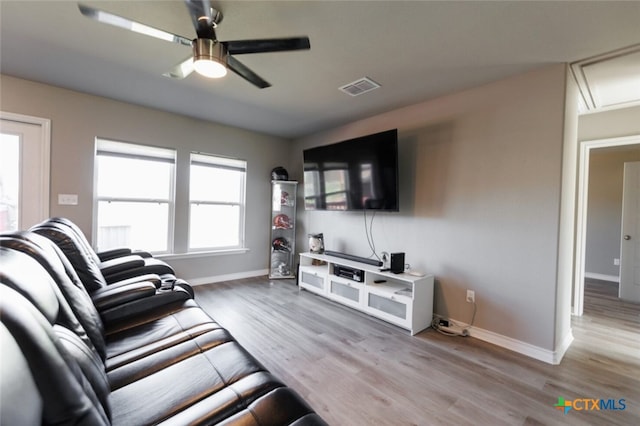 living room featuring light hardwood / wood-style flooring and ceiling fan