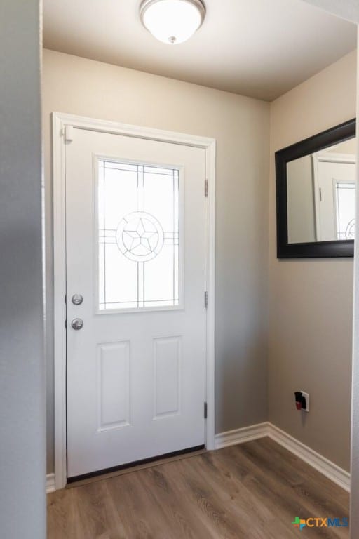 doorway to outside with dark hardwood / wood-style floors