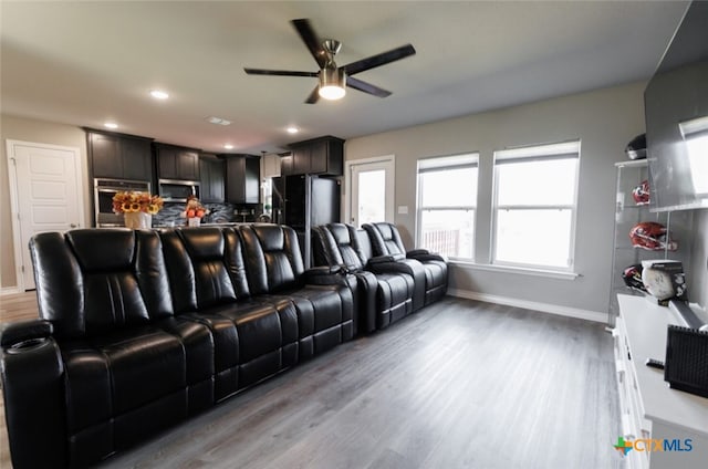 home theater featuring ceiling fan and light wood-type flooring