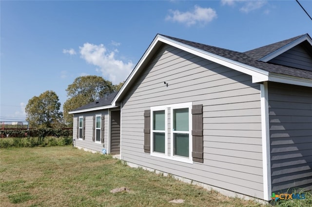 view of side of property featuring a yard