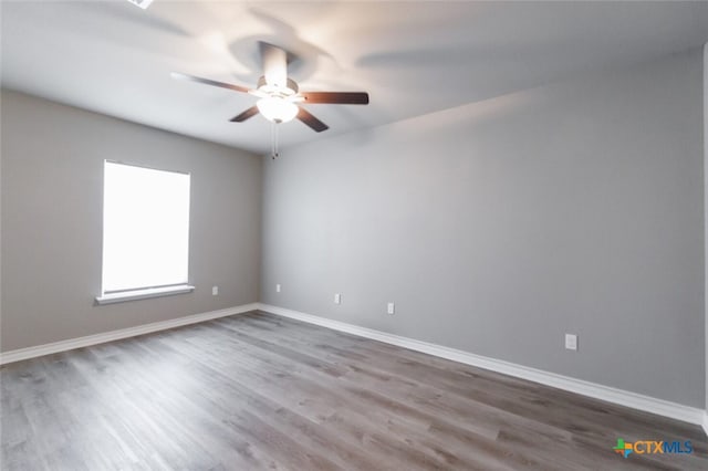 spare room with hardwood / wood-style flooring and ceiling fan