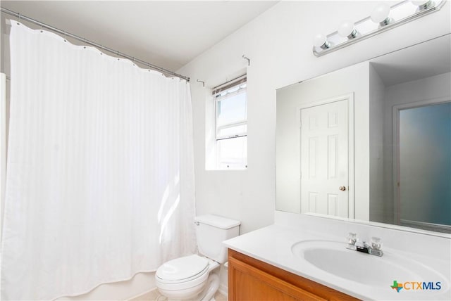 bathroom featuring toilet and vanity