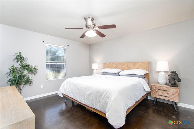 bedroom with a ceiling fan, finished concrete flooring, and baseboards