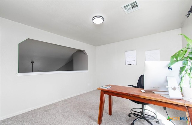 carpeted office space featuring baseboards and visible vents