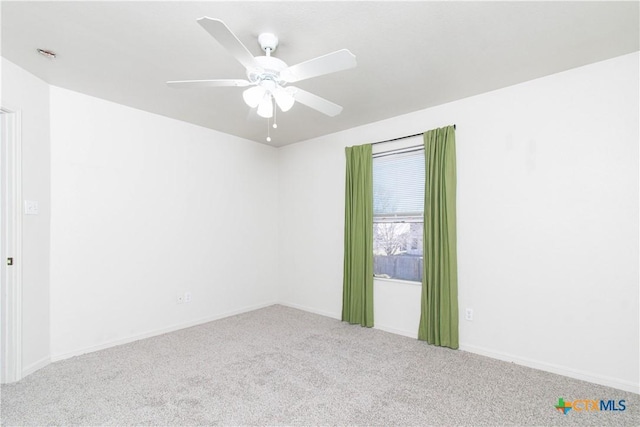 empty room featuring carpet floors and ceiling fan