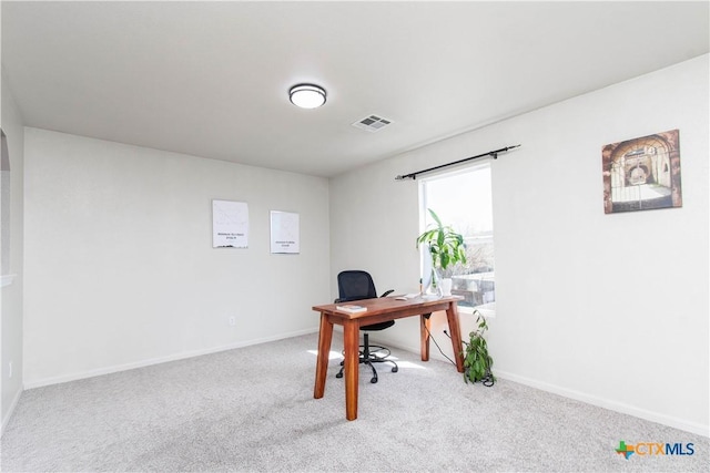 office space featuring carpet floors, visible vents, and baseboards