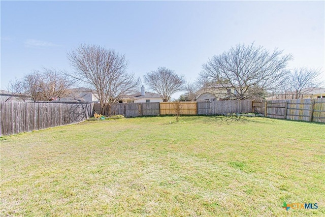 view of yard featuring a fenced backyard