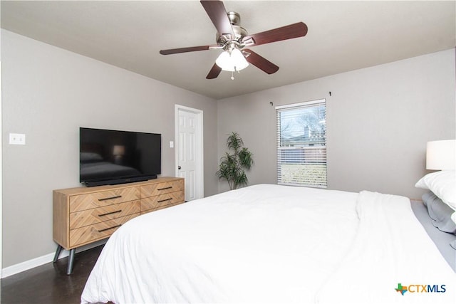 bedroom featuring dark wood finished floors, a ceiling fan, and baseboards