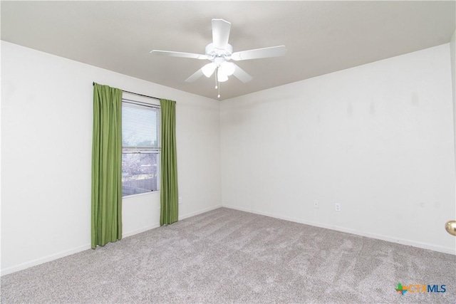 empty room featuring a ceiling fan and carpet flooring