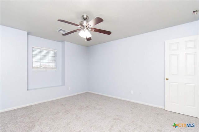 unfurnished room featuring ceiling fan, carpet, visible vents, and baseboards