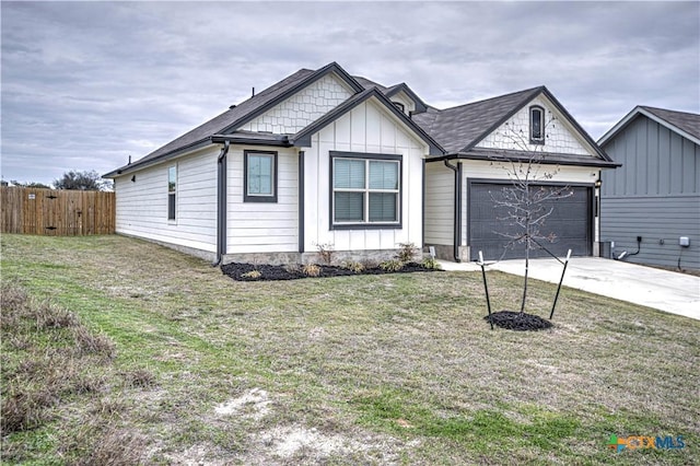 view of front of property with a garage and a front lawn