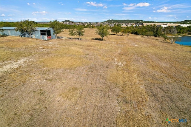 birds eye view of property featuring a rural view and a water and mountain view