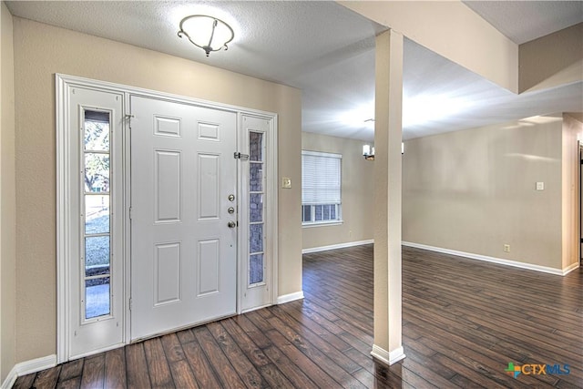 foyer entrance featuring dark hardwood / wood-style floors and a textured ceiling