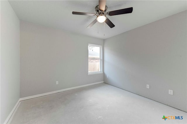 unfurnished room featuring concrete floors, baseboards, and ceiling fan