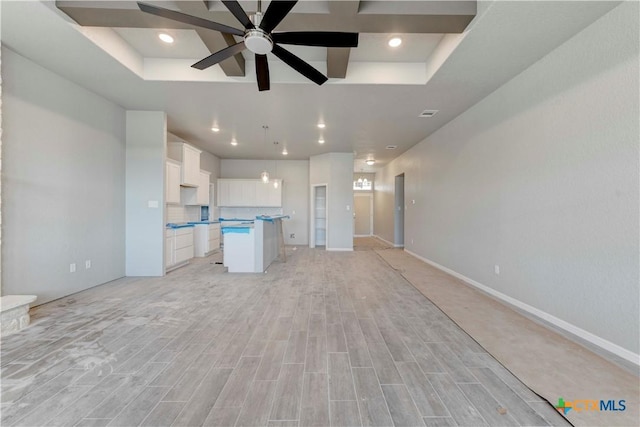 unfurnished living room featuring light wood-type flooring, a ceiling fan, and recessed lighting