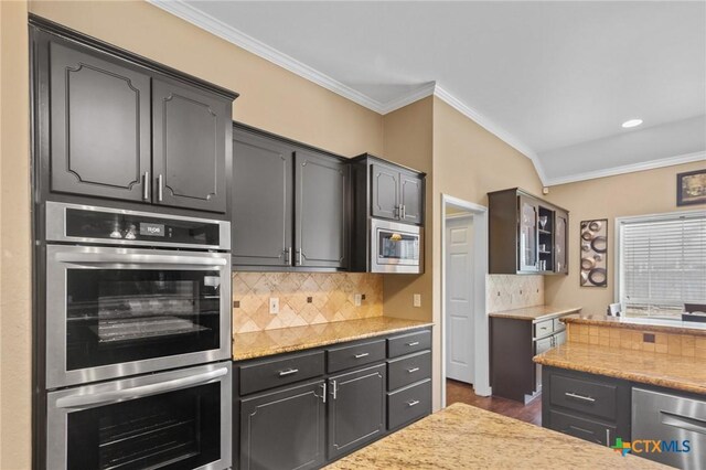 204 Crosswind Dr, Victoria, TX 77904 - kitchen with stainless steel appliances, crown molding, decorative backsplash, and glass insert cabinets