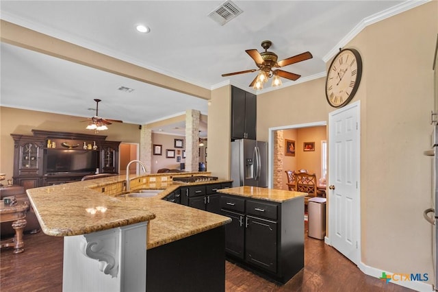 204 Crosswind Dr, Victoria, TX 77904 - kitchen featuring stainless steel fridge with ice dispenser, an island with sink, a ceiling fan, dark cabinets, and dark wood-style floors