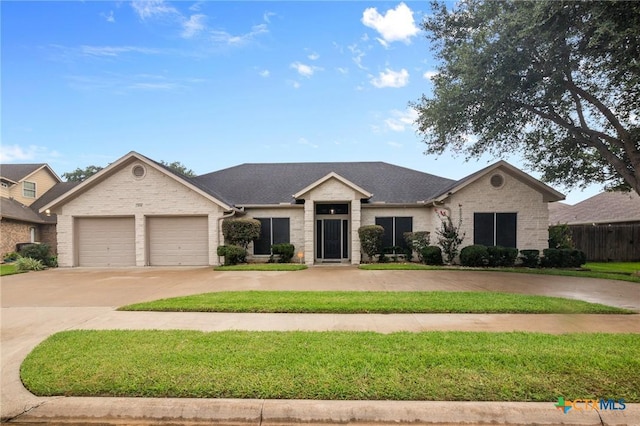 204 Crosswind Dr, Victoria, TX 77904 - view of front facade with concrete driveway, a garage, and brick siding