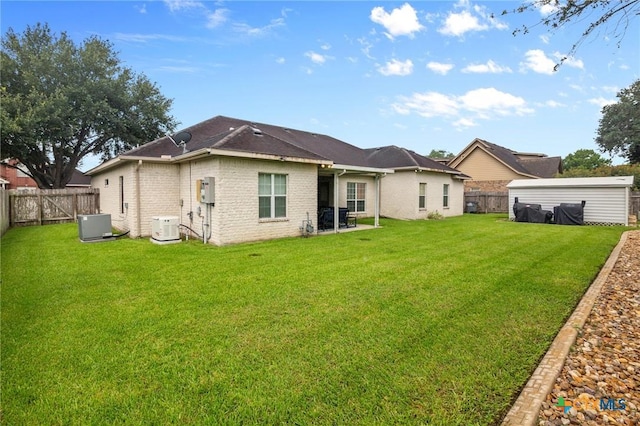 204 Crosswind Dr, Victoria, TX 77904 - rear view of house with a fenced backyard and brick siding