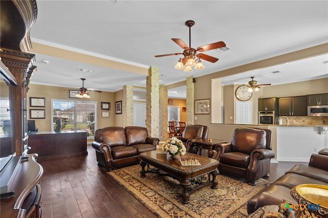 204 Crosswind Dr, Victoria, TX 77904 - living room featuring ceiling fan, dark wood-style flooring, ornamental molding, and decorative columns