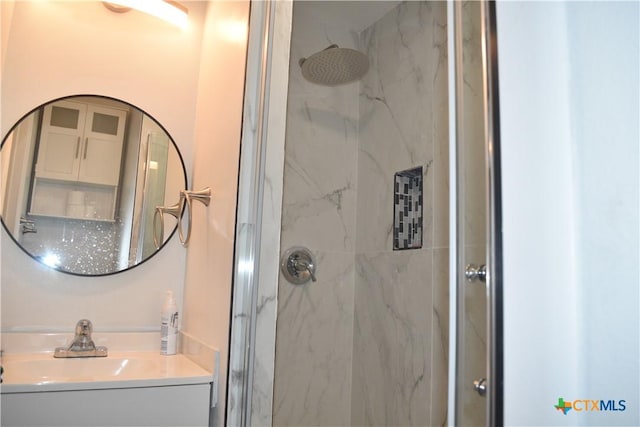 bathroom with an enclosed shower and sink