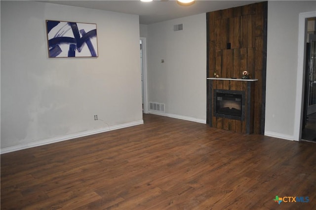 unfurnished living room featuring dark hardwood / wood-style floors and a fireplace