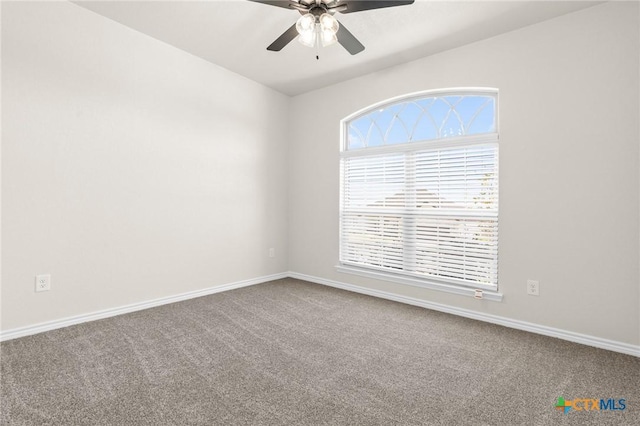 carpeted spare room featuring ceiling fan