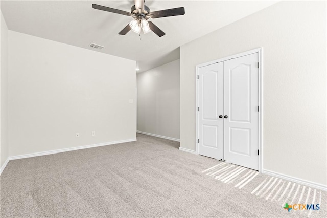 unfurnished room featuring ceiling fan and light carpet