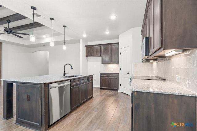 kitchen with dishwasher, light stone countertops, sink, and decorative light fixtures