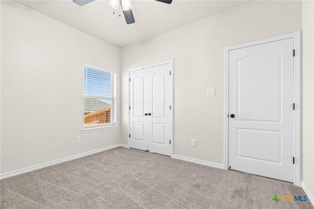 unfurnished bedroom with ceiling fan, a closet, and light colored carpet