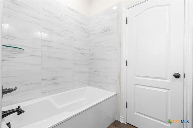 bathroom with tiled shower / bath and hardwood / wood-style flooring