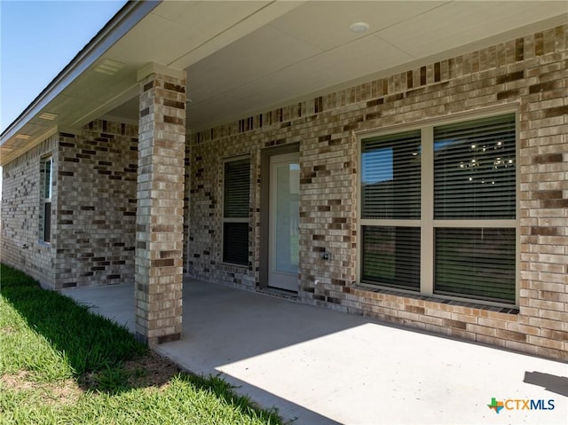 property entrance featuring a patio area