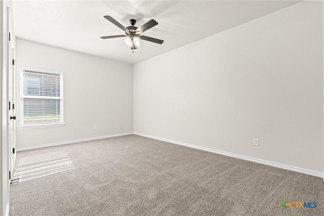 carpeted spare room featuring ceiling fan