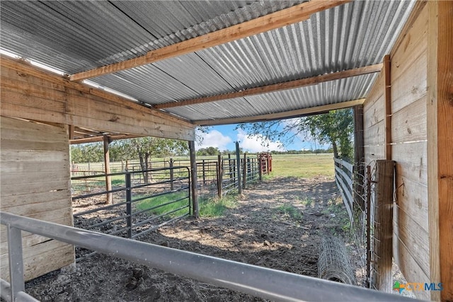 view of stable with a rural view