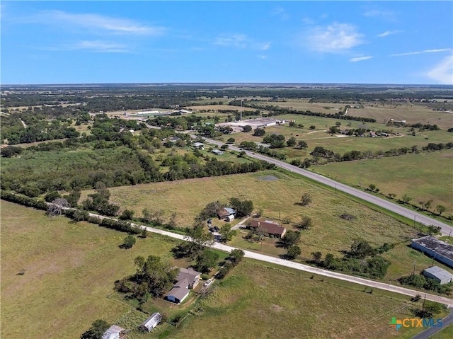 birds eye view of property with a rural view