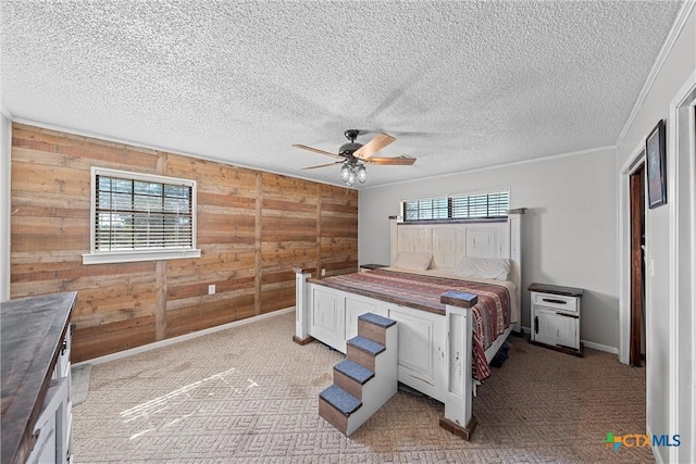 bedroom featuring ceiling fan, wood walls, and multiple windows