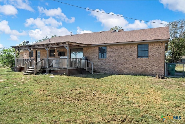 rear view of property with a lawn