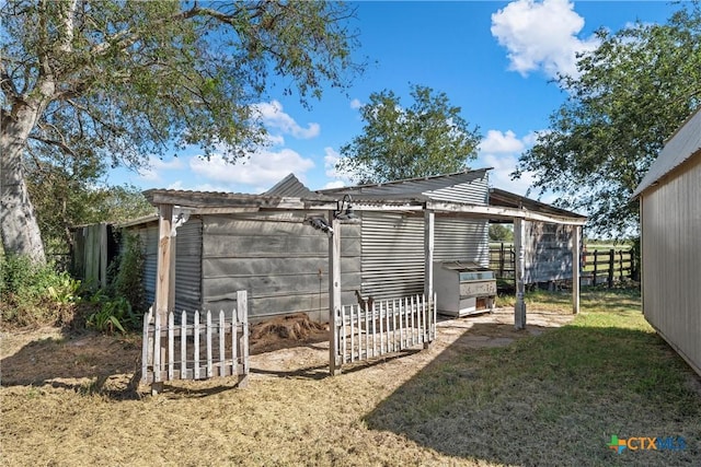 view of outbuilding with a lawn