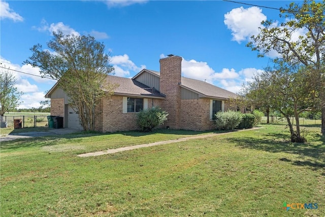 exterior space with a garage and a yard