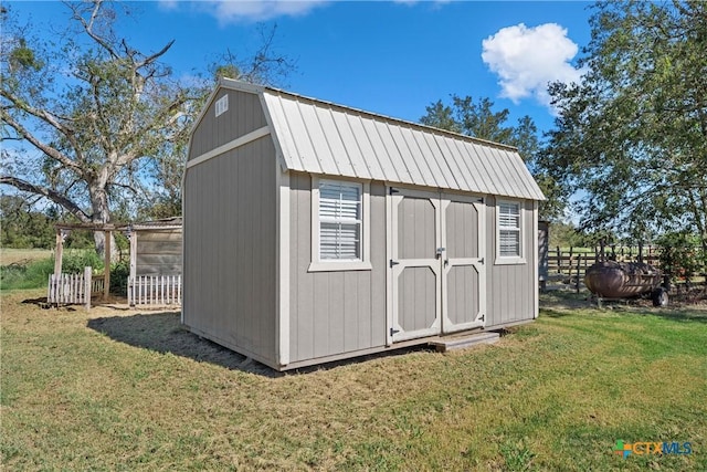 view of outbuilding featuring a lawn